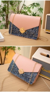 Detail of pink PU leather and blue-black sequin crossbody bag with golden lock