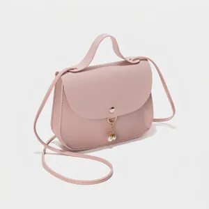 Pink PU leather crossbody handbag with gold chain and pearl charms in top view