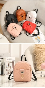 Detail of five mini quilted leather backpacks with Mickey shape metal charms and star pendant