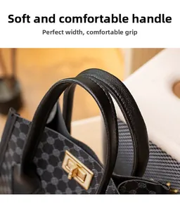 Detailed close-up of a soft leather handle and golden twist lock on a mini handbag