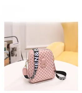 Detail view of pink crossbody bag with geometric dots and adjustable wide strap dimensions