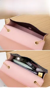 Internal storage detail of pink and black chain bag showing phone and lipstick space
