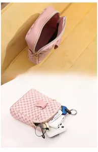 Pink crossbody bag interior showing storage space for phone, glasses and power bank