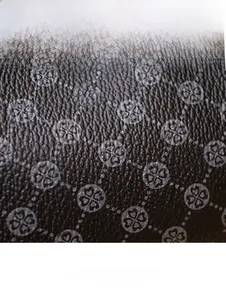 Detailed close-up of textured leather fabric with elegant clover-shaped heart pattern