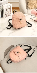 Detailed close-up of pink quilted mini backpack featuring a gold Mickey Mouse clasp
