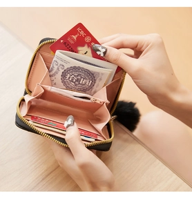 Detail of black leather wallet interior with card slots and pink lining sections