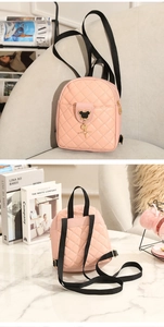 Close-up of pink quilted mini backpack featuring a Mickey silhouette metal buckle