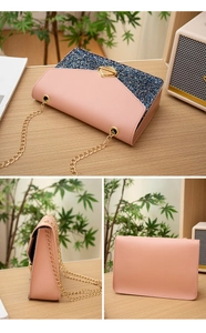 Detail view of a pink and blue sequin chain bag with a gold geometric clasp