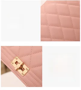 Detail of pink quilted leather texture and gold-tone square twist lock on women bag