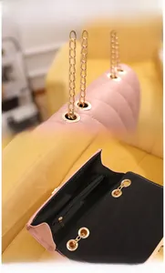 Detailed view of pink quilted handbag with gold chain strap and interior zip pocket