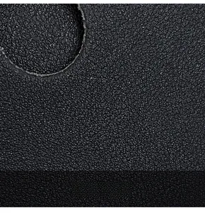 Close-up of premium black lychee leather texture showing refined grain and detail