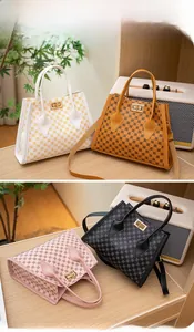 Detail of mini Kelly bag with metal twist lock and geometric monogram print
