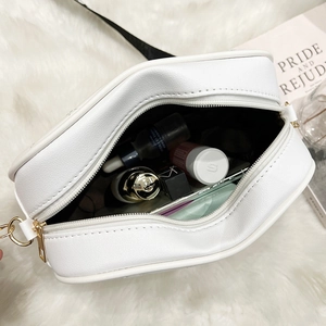 White quilted crossbody bag with gold hardware showing daily essentials capacity