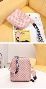 Macro detail of pink cross-body bag with geometric prints and wide lettered strap