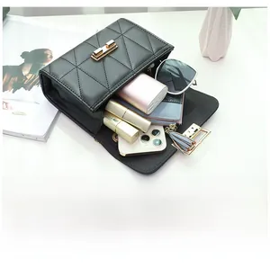 Interior detail of black quilted handbag showing large capacity for phone and cosmetics