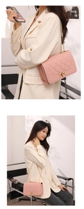 Detailed view of pink quilted handbag with gold chain strap and square lock closure