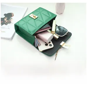 Interior view of green quilted bag showing storage for phone, wallet and lipstick
