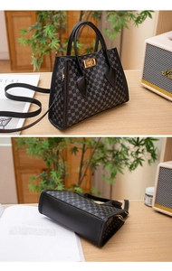 Close-up of geometric pattern crossbody bag with gold hardware and canvas strap