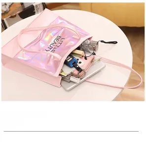 Macro view of large pink tote bag interior showing capacity for cosmetics and tablet