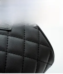 Macro shot of black quilted faux leather handbag with high-quality diamond stitching