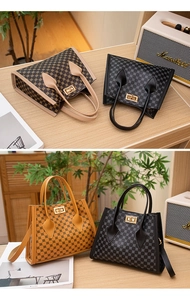 Detailed view of mini Kelly style bags with circle pattern and golden twist lock closure