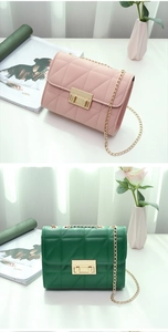 Detail of pink and dark green quilted chain bags with golden twist locks and metal straps