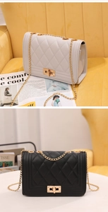 Detail of quilted diamond pattern and golden chain strap on classic flap bag