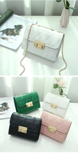 Detail of quilted square bag with gold buckle and chain strap in multiple colors