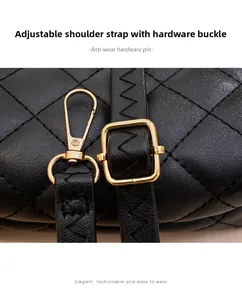Close-up of adjustable golden hardware and quilted leather texture on black tote bag