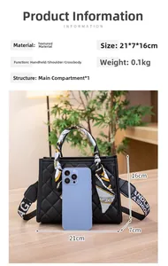 Detail of black quilted shoulder bag featuring silk scarf handle and wide printed strap