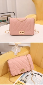 Detailed view of pink quilted chain shoulder bag with gold hardware and rhombic pattern