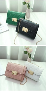 Detail view of four diamond-quilted leather bags in green, black, pink, and white colors