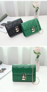 Quilted crossbody bag with gold chain and metal buckle in black and green colors