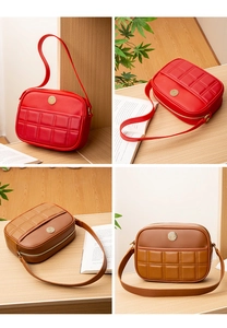 Detail view of red and brown quilted leather shoulder bags with gold metal emblems