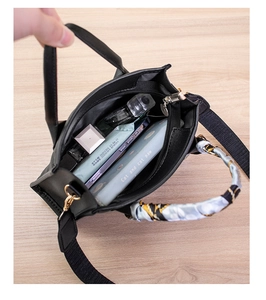 Interior view of black quilted handbag showing spacious capacity for phone and accessories