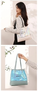 Detailed view of large holographic laser tote bag with Little Beauty slogan and PVC texture