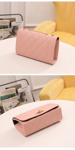 Detail of pink quilted crossbody bag showing gold chain strap and elegant turn-lock closure
