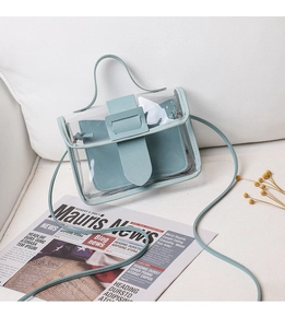 Detail of transparent crossbody bag with mint green trim and matching inner pouch