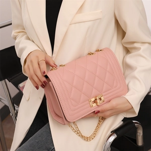 Elegant pink quilted crossbody bag with gold chain strap and metal swivel lock buckle