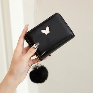 Mini black patent leather purse with white butterfly and fluffy pompom keychain