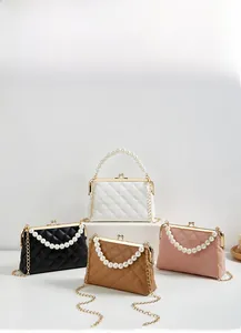 Quilted crossbody bag with pearl handle and gold clasp in four classic colors