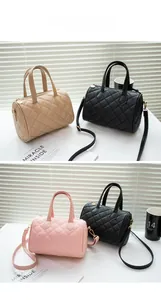 Detailed view of quilted Boston handbags in black, beige, and pink with gold metal hardware