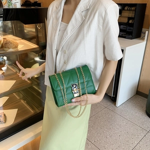 Green quilted faux leather crossbody bag with golden chain strap and twist lock