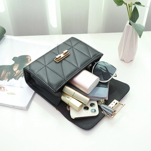 Black quilted crossbody bag with gold hardware showing spacious interior with daily essentials