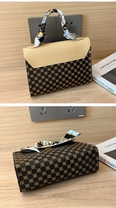 Detail of vintage patterned square handbag with silk scarf wrapped handle and beige flap