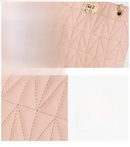 Detailed macro view of pink quilted PU leather bag with precise stitching and gold metal lock