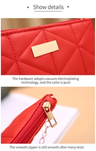Detail of red quilted PU leather bag with gold metal hardware and smooth zipper