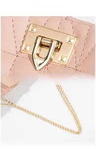 Detail of pink quilted leather bag with high-polish gold hardware and vacuum plating