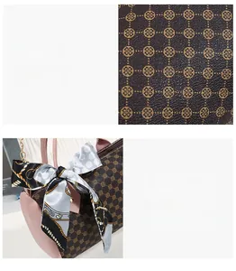 Détail d'un sac Boston marron avec motifs d'anneaux dorés et foulard en soie