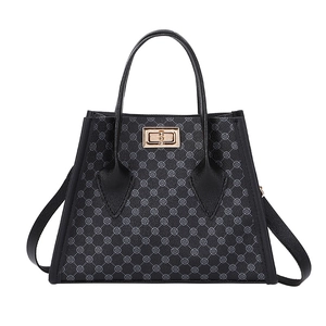 Classic black patterned tote bag with gold hardware and a detachable shoulder strap